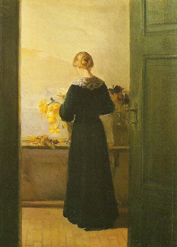 Anna Ancher en ung pige ordner blomster